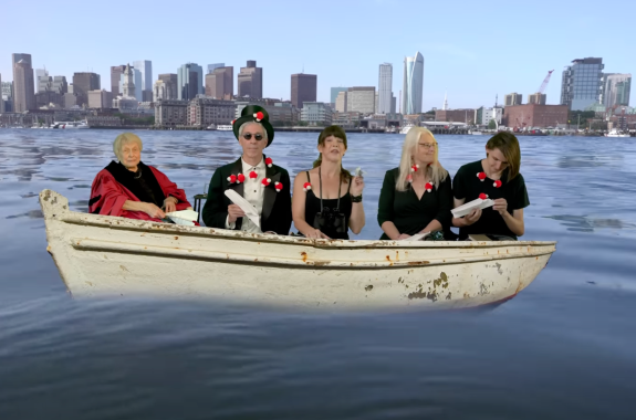 Five people dressed formally on a virtual boat, holding paper airplanes.