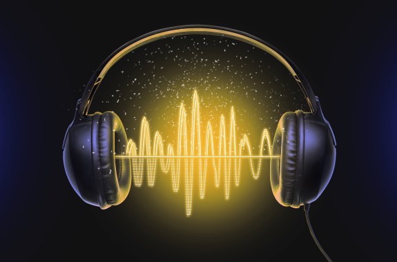 Black music headphones and sound waves with glow