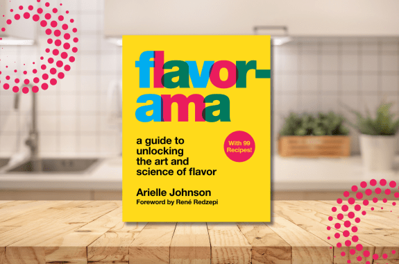 Book Cover for "Flavorama" in front of a kitchen with wooden table surface