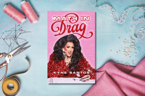 A drag queen wearing a shiny red shirt that looks like it's made of wrapping ribbons. She's smiling at the camera, holding a calculator and a pencil. Behind her are math equations and formulas. Background of sewing equipment