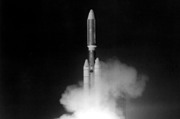 A rocket launching into space in a black and white photo