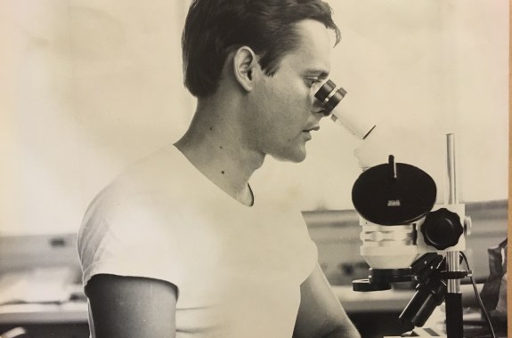 A man looking into a microscope