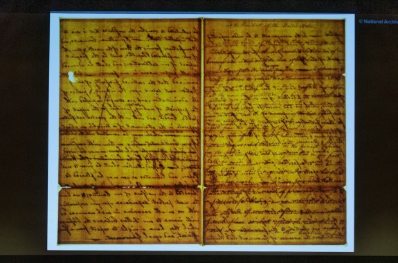 A yellowed document projected onto a screen