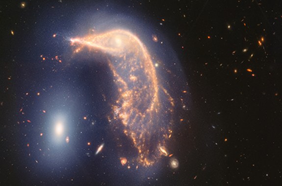 A glowing galaxy shaped a bit like a penguin, with a glowing "eye" at the center. A bright spot to the left is "the egg"