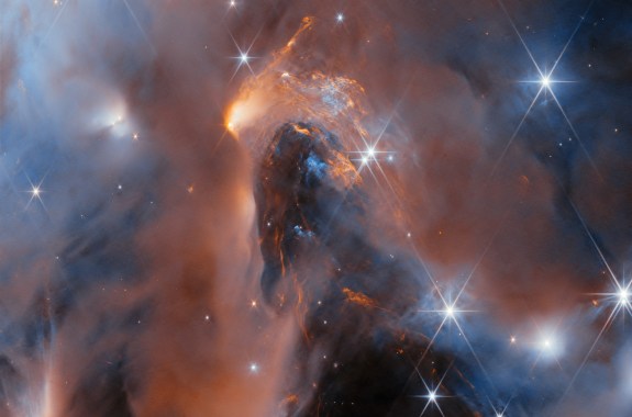 A dreamy space cloud swirl with bright stars