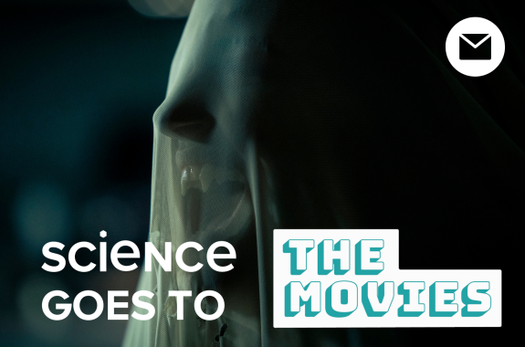 A woman's head covered in a veil, with vampire fangs visible in her mouth