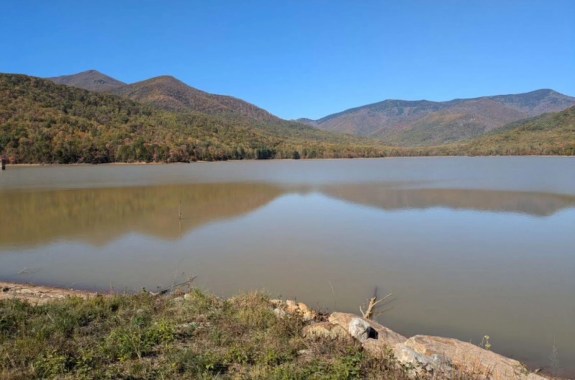 A body of water surrounded by mountainous terrain