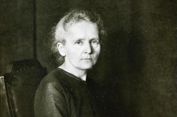 Marie Curie sitting for a photo portrait
