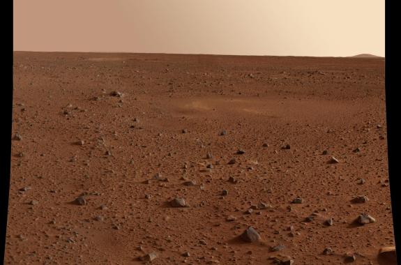 A landscape with reddish rocks and ground. A blank, yellow-ish sky