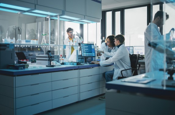 Modern Medicine Research Laboratory: Diverse Team of Multi-Ethnic Young Scientists Analysing Test Samples. Advanced Lab with High-Tech Equipment, Microbiology Researchers Design, Develop Drugs
