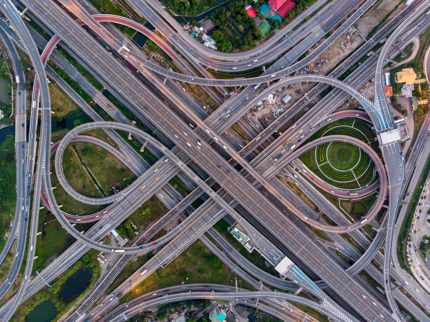 High angle looking top down view of complicate road and expressway intersection in Bangkok city of Thailand. Shot by drone can use for transportation or abstract concept. Road design