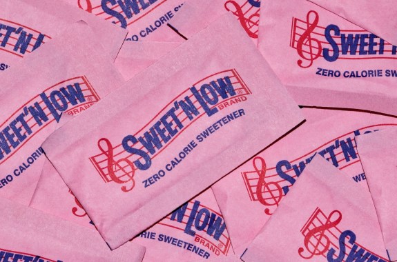 Sweet 'N Low packets scattered loosely, full frame macro image. Artificial sweetener and sugar substitute, it is made by Cumberland Packing Corporation in the USA.