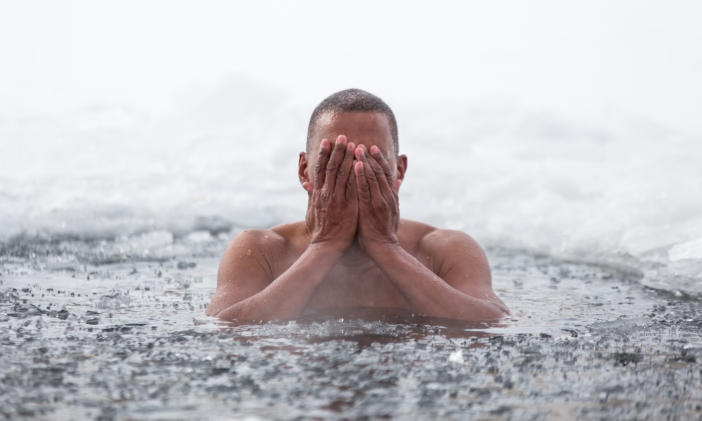 Cuban man swims in an ice hole in winter