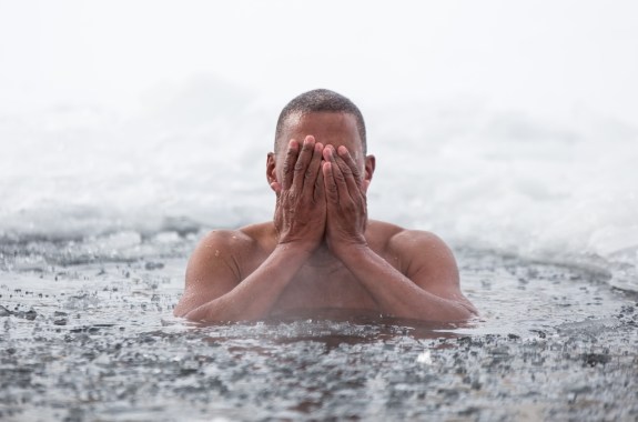 Cuban man swims in an ice hole in winter