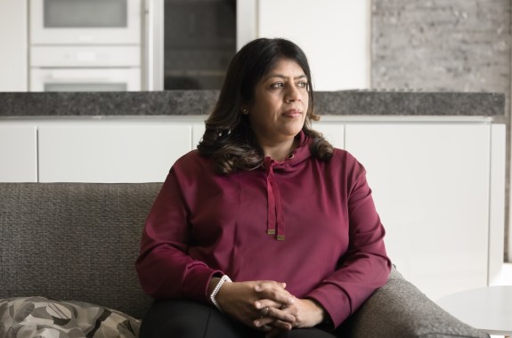 Serious pensive mature Indian woman looking away with thoughtful face from home couch, sitting on sofa, daydreaming, thinking on troubles, problem solving, making decision, menopause