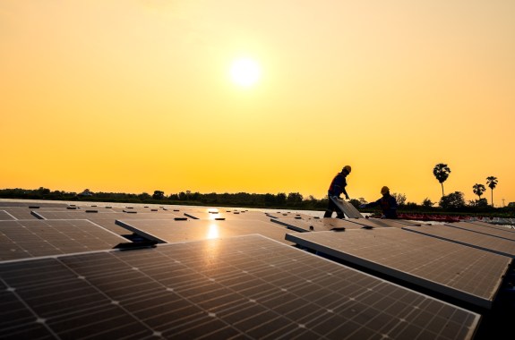 Photovoltaic engineers work on floating photovoltaics. workers Inspect and repair the solar panel equipment floating on water. Engineer working setup Floating solar panels Platform system on the lake.