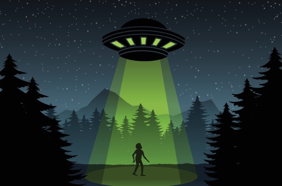 A cartoon of a UFO at night sending green beams down onto a human against a forest backdrop