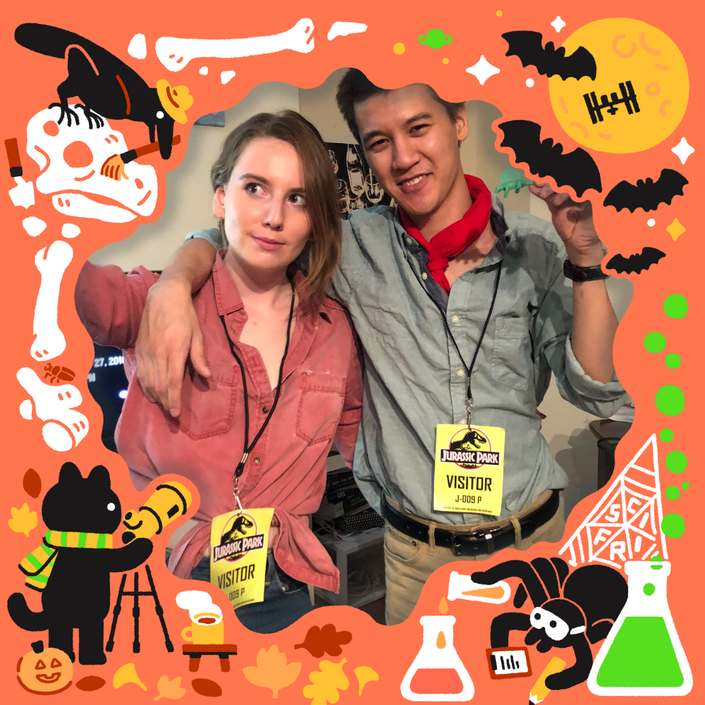 Two people wearing lanyards that say "Jurassic Park Visitor"